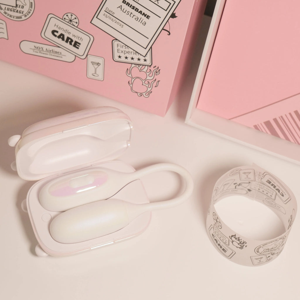 Open suitcase charger showing white beginner vibrator and couples blindfold inside