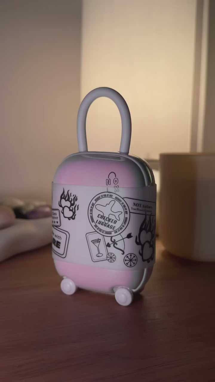 Creator unboxing the NOX Traveller Gift Set, showing the mini suitcase case, connection cards and UV charging