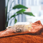 Quiet beginner vibrator nestled inside its open charging case on a bed