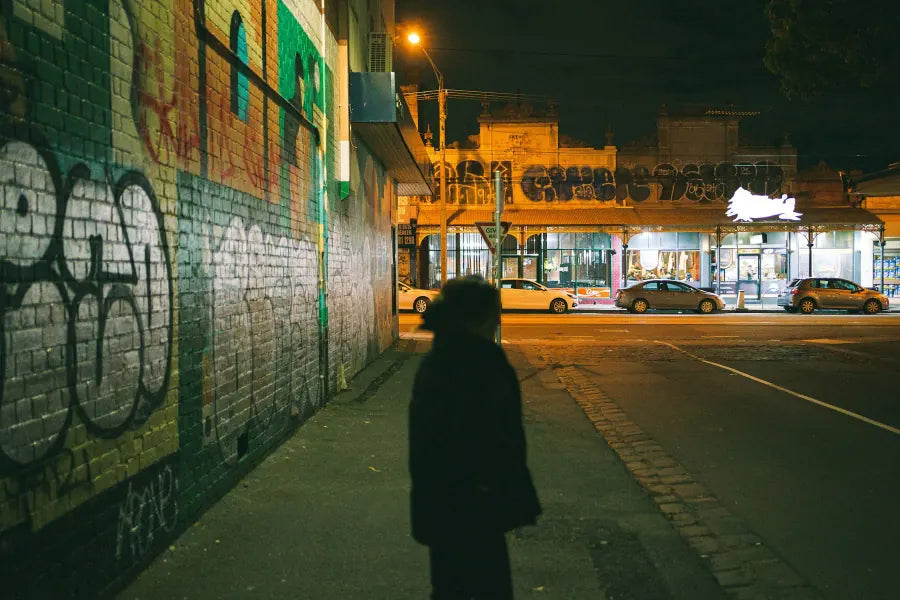 A person walking beside street art in Brunswick, Melbourne