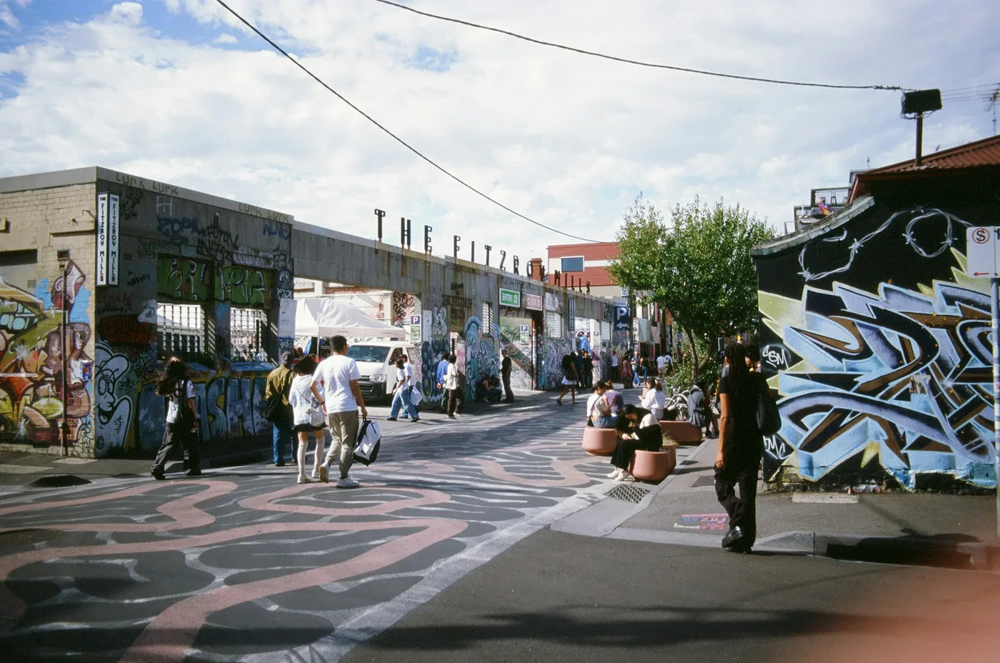 People walking through street art at the Fitzroy Mills in Melbourne